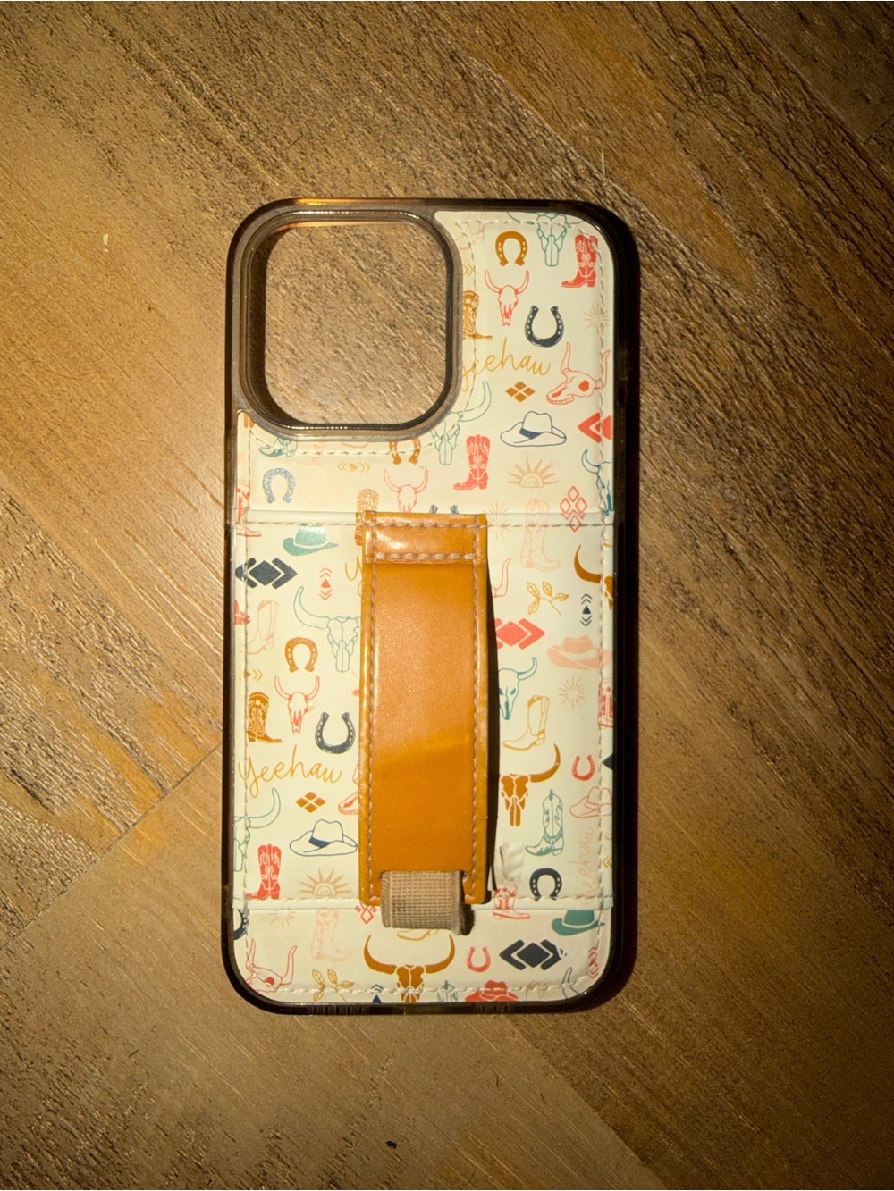 iPhone 14 Pro Max. Cream Pattern Phone Case with Tan Leather Hand Strap